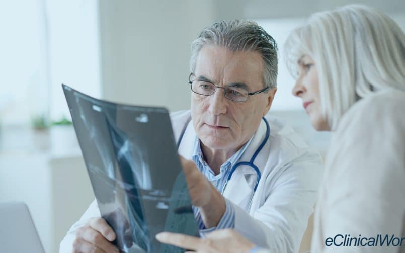 Rheumatologist looking at an xray with a patient