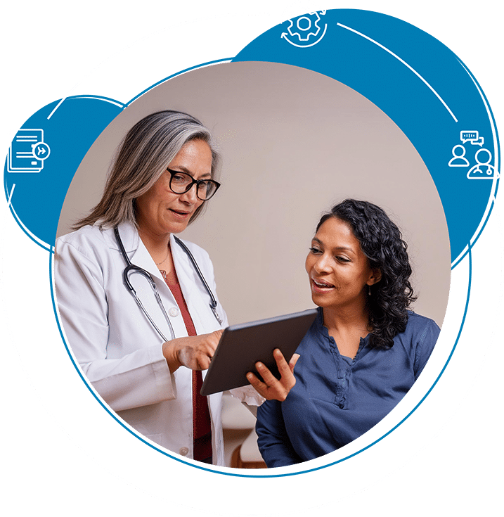 A doctor using a tablet while talking to a patient